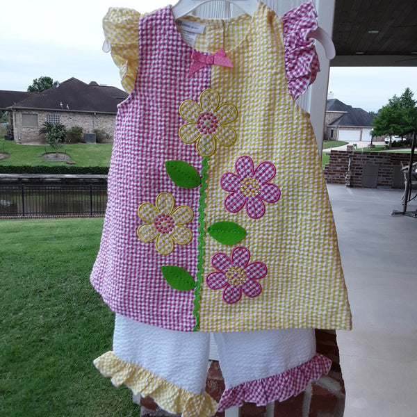 Pink & Yellow Appliqued flowers growing off of a lime green stem.