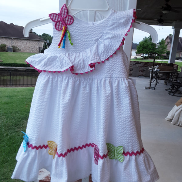 White Seersucker sleeveless dress with hot pink ricrac & multi colored gingham butterfly accents