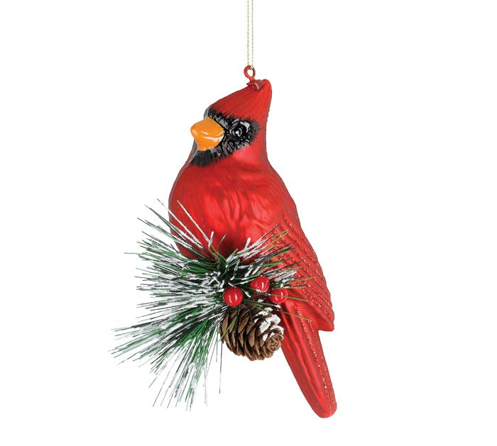 Cardinal sitting on branch ornament
